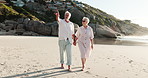 Senior couple, walking and holding hands on beach for outdoor date, bonding or sightseeing together. Elderly, woman and man pointing with view or sandy shore for holiday or vacation on ocean coast