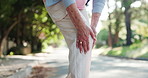 Elderly person, hands and knee injury with pain on road for workout accident or emergency. Closeup, senior or sore bone with leg for muscle tension, bruise or sprain on street in neighborhood town