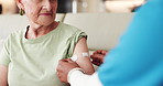 Nurse, old woman and hands with bandage for vaccine in home, healthcare and medical wellness. Caregiver, plaster and happy elderly patient with virus safety, homecare and immunity in retirement