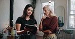 Women, hairdresser and discussion with tablet in salon for small business startup together. Female people, colleagues or employees talking with technology for stock or online booking in beauty parlor