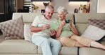 Old couple, relax and tablet on sofa for social media, streaming or subscription in living room. Elderly man, woman or senior people in house together for retirement, bonding and beverage with tech