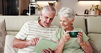 Elderly couple, relax and tablet on couch for social media, streaming or subscription in living room. Old man, woman or senior people in house together for retirement, bonding and beverage with tech