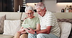 Elderly couple, smile and tablet on sofa for social media, streaming or subscription in living room. Old man, woman or senior people in house together for retirement, bonding and love with tech