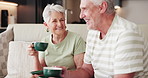 Home, coffee and old couple on sofa, funny and bonding together with joke, love and trust. Happy, man and woman with caffeine, smile or retirement with break, herbal tea or laughing with relationship