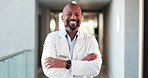 Doctor, healthcare or black man with arms crossed, face or confidence with career ambition. Mature person, smile or professional in clinic, wellness or medical service with pride or cardio specialist