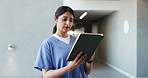 Clinic, nurse and woman with tablet for healthcare, wellness email and history in hallway. Serious, person and medical worker with tech in hospital, review schedule and scroll records for telehealth