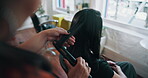 Hands, women and styling with equipment at salon for haircare, curly hair and volume treatment. Above, person or hairstylist with flat iron for blowout maintenance, waves textures and hairstyle shine