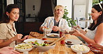 Break, food and social gathering with friends at dining table in home for bonding or celebration. Cookout, lunch and reunion with group of happy people in apartment for eating, feast or meal