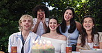 Happy people, face and singing with birthday cake for party celebration or outdoor gathering. Portrait, friends or smile with surprise, candles or dessert for annual event or year together in nature