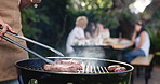 Barbecue, hands and tongs with people in backyard of home for reunion or social gathering. Cooking, food and meal preparation with bbq meat on grill for cookout, get together or hangout outdoor