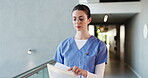 Documents, healthcare and walking with woman nurse in hospital for planning or research. App, medical and reading with person in clinic hallway for insurance, internship or review of information