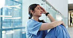 Medical, sad and woman in hospital with thinking, patient loss and worry for emergency risk. Healthcare, reflection and surgeon on floor with guilt, operation anxiety and bad news in surgery result.