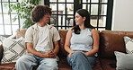 Couple, relax and talking on sofa at house for first date, explain interests and bonding together. Smile, people and discussion on couch for commitment, romantic conversation and connection in lounge