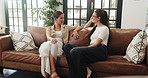 Friends, relax and women in home for gossip, surprise and laugh together on sofa. Happy girls, talking and conversation in living room for communication, funny story or shock with news on hangout