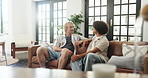 Men, talking and relax with sofa in home for conversation, social or bonding together. Male people, friends or chatting with comfort on living room couch for friendly discussion or communication