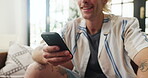 Typing, hands and man on sofa with phone for social media, online chatting and communication. Relax, home and person on smartphone for internet, website and networking in living room on weekend