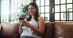 Happy, laugh and woman on sofa with phone for social media, online chatting and communication. Relax, home and person on smartphone for internet, website and networking in living room on weekend