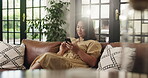 Phone, relax and scrolling with woman on sofa in living room of home for social media browsing. App, text message and typing with happy person in apartment for communication, me time or wellness