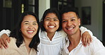 Happiness, face and Asian family in house with hug, bonding together or care in healthy relationship. Smile, parents or daughter in home with embrace, connection or security for childhood development