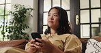 Phone, relax and thinking with woman on sofa in living room of home for social media browsing. App, ideas and text message with happy person in apartment for communication, me time or wellness