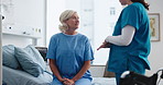 Senior woman, patient and nurse with hospital bed for assisted living or healthcare in clinic. Elderly, caregiver or female person with a disability or wheelchair for medical advice, help or support