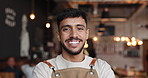 Face, barista and man in cafe with smile, confidence and  career pride with bokeh in startup. Portrait, waiter and happy person in coffee shop, hospitality or customer service in small business