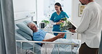 Nurse, old man and family with flowers at hospital bed for patient care, visit and recovery support. Healthcare, senior dad and visitor with bouquet in clinic for wellness, get well soon and healing