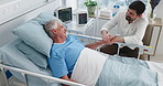 Hospital bed, senior man or son with patient visit for support, conversation or recovery in medical care. Healthcare, holding hands or people with comfort for family, healing or high angle in talking