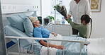 Grandmother, kid and parent with flowers at hospital bed for recovery support, visit and surprise. Healthcare, family or bouquet to senior patient in clinic for get well soon, love or surgery healing