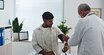 Blood pressure, check up and doctor with man in clinic for medical exam, support and consulting. Healthcare, hospital and patient with equipment to monitor for heart rate, wellness and hypertension