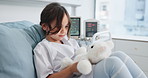 Healthcare, teddy bear and child play on hospital bed for surgery recovery, healing and wellness. Pediatric clinic, patient and kid with stuffed animal, medical and girl resting with fluffy toy