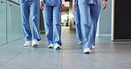 Group, legs of nurses and walking in hospital corridor for medical service, ward round and teamwork. Nursing staff, people and on the move in clinic hallway for healthcare treatment and shift start