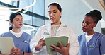 Coaching, conversation or tablet with doctor and nurses in hospital for internship feedback. App, healthcare and teaching with woman speaking to students in medical clinic for development or learning