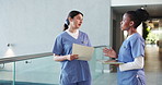 Nurse, team and conversation in hospital with folder for disappointing news, feedback or update. Upset, healthcare worker walk and people talk with document for medical info, patient report or issue.
