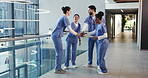 Applause, hand stack and success with medical team in hospital for motivation or support. Clapping, healthcare and huddle with doctors and nurses in hallway of clinic together for collaboration