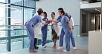 Applause, hand stack and medical with excited people in hospital for motivation or support. Clapping, huddle or healthcare with doctors and nurses in clinic together for collaboration or success