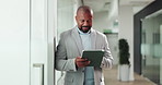 Mature man, tablet and happy with scroll at office, notification or deal for real estate project. African person, realtor and property developer with tech, app and smile with proposal in corridor