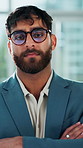 Realtor, face or man in office with arms crossed, pride and experience as property seller. Serious, glasses or real estate agent in workplace with confidence, about us or profession in housing market