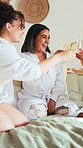 Cheers, smile and friends in hotel with champagne, bonding and congratulations on bachelorette trip. Happy, women and bridesmaid at resort with toast, sparkling wine or celebration at bridal shower.