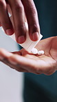 Hands, person and pills for medicine, healthcare or prescription drugs for wellness in home. Palm, pour medication or bottle with supplements, pharma treatment or medical benefits with cure closeup