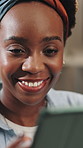 Black woman, tablet and happy in home, laugh and scroll for funny meme on break for remote work. African person, freelance writer and relax with tech, chat or streaming video on web at apartment