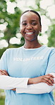 Face, volunteer and happy woman with arms crossed outdoor for community service, non profit or laugh. Park, charity worker and confident black person with NGO, outreach and funny portrait with bokeh