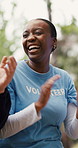 Woman, laugh and volunteer with applause in park for good news with charity success. Happy, people and clapping hands for community service goals, fundraising achievement and team motivation outdoor