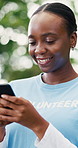 Volunteer, smartphone and black woman in park, smile and program for donation, texting and email. NGO, outdoor and happy person with tech, social media campaign and app for sign up or charity project