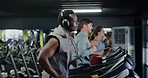 Headphones, running and man on treadmill in gym for fitness, workout or training with health. Wellness, audio tech and male person listening to music for cardio exercise on machine in sports center.
