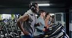 Headphones, sports and man on treadmill in gym for running, workout or training with health. Wellness, audio tech and male person listening to music for cardio exercise on machine in fitness center.