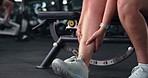 Person, hands and fitness with leg injury for muscle tension, sprain or overworked in gym. Closeup, active or calves with sore shin or bone for strain, joint inflammation or accident in health club