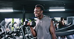 Fitness, weightlifting or athlete in gym with dumbbell, training or bicep curl in bodybuilding. Happy, exercise or man in club with equipment, intense workout or strength in muscle transformation.