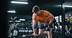 Dumbbell, health and man in gym, fitness and training with endurance, exercise goals and strong. Person, equipment or sports athlete with core strength, workout or challenge with power or bodybuilder