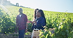 People outdoor, walk and chat in vineyard for winery education, sustainable farm and agriculture. Countryside, tour guide or group in nature with grape vines, farming conversation or winemaking info.